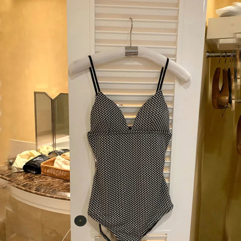 Blue and black women's one-piece polyester swimsuit for hot springs, shown in sizes M, L, and XL.