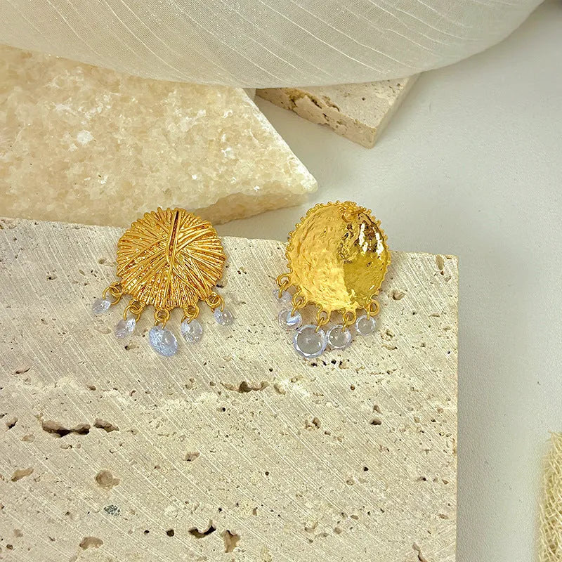 Geometric gold metal hoop earrings with round design elements