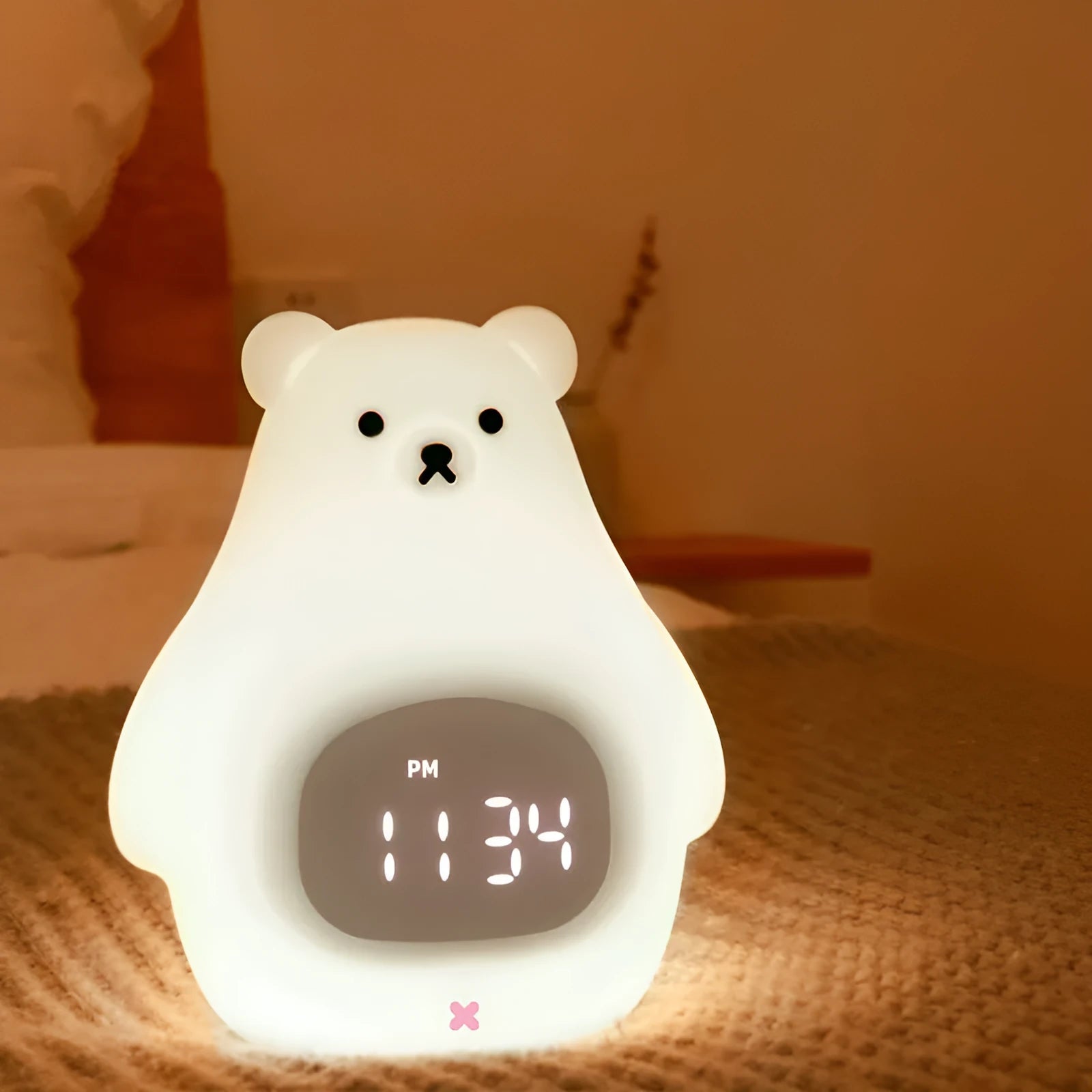 White cartoon bear silicone night light with remote control on a surface.