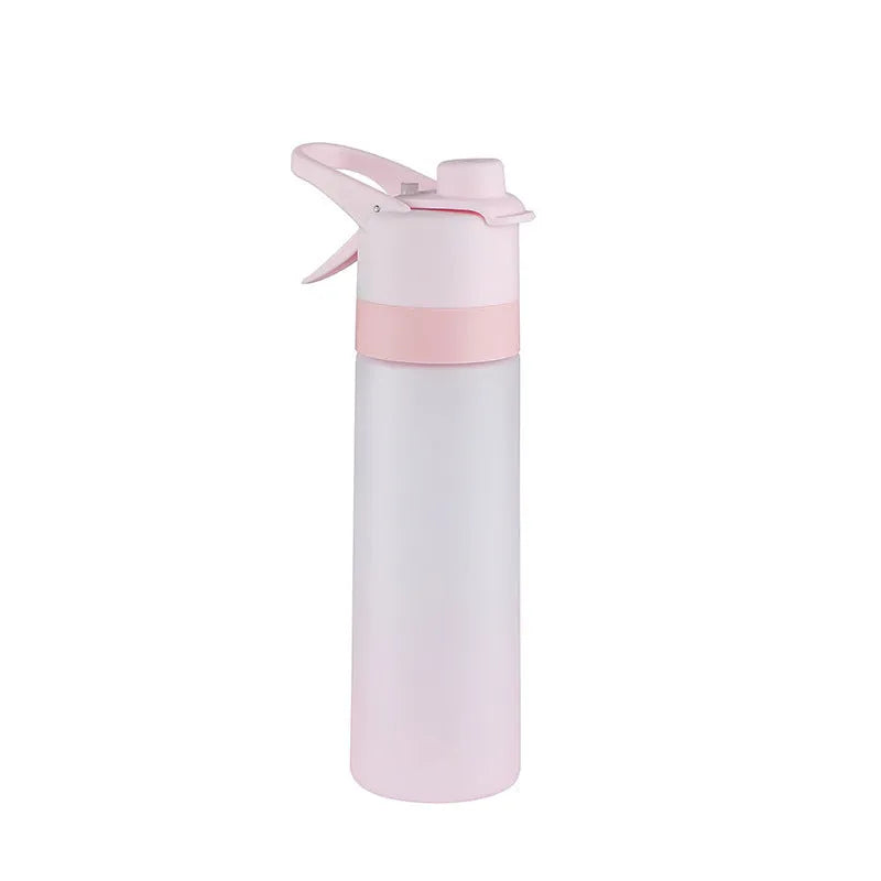 White 700ml plastic spray water bottle with a black handle strap and leakproof lid on a table.
