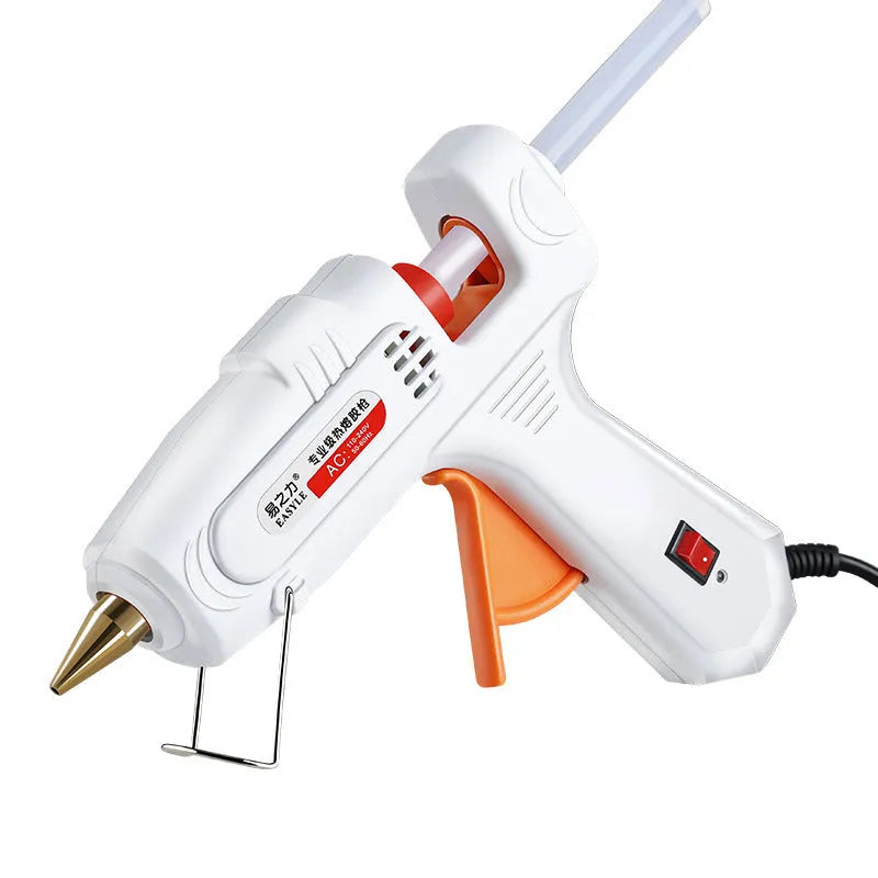 White electric hot glue gun with metal stand and safety switch.