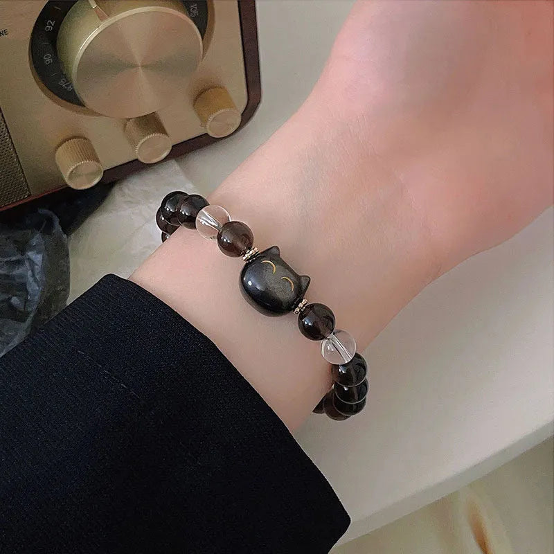 Close-up of women's silver bracelet with 8mm opal ice stone and cat head charm.