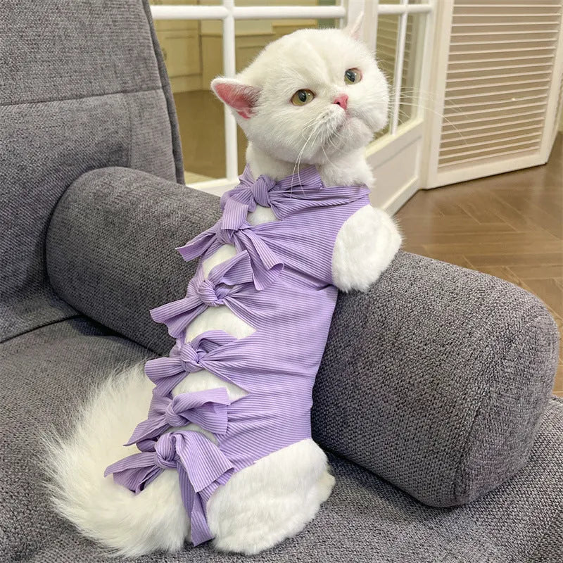 Lace-up polyester recovery clothing for a cat, shown in a choice of colours including blue, pink, and green pineapple.
