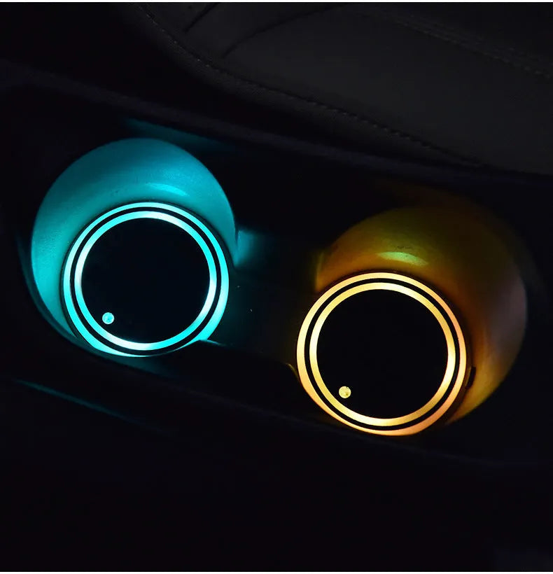 Colourful LED light-up car coaster in a vehicle cup holder, showing multiple light colours.