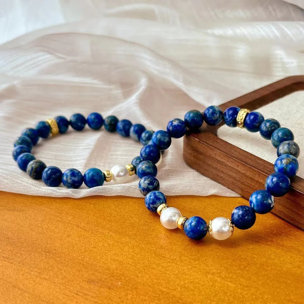 Natural green and gold lapis lazuli stone bracelet with a Chinese retro design on a wrist.