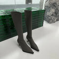 Black pointed toe women's ankle boots with a stiletto heel and a back zipper closure.