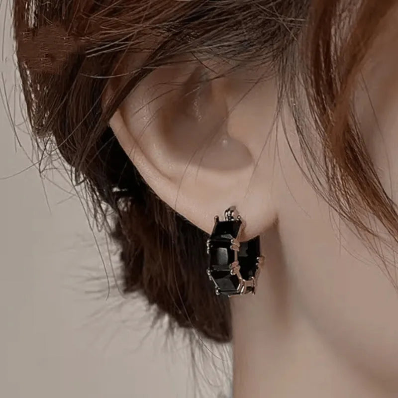 Geometric U-shaped drop earrings with zircon stones in black, pink or white colours on gold electroplated copper
