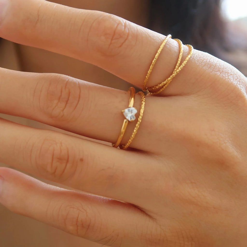 Golden electroplated stainless steel love heart ring for women showing heart shape.