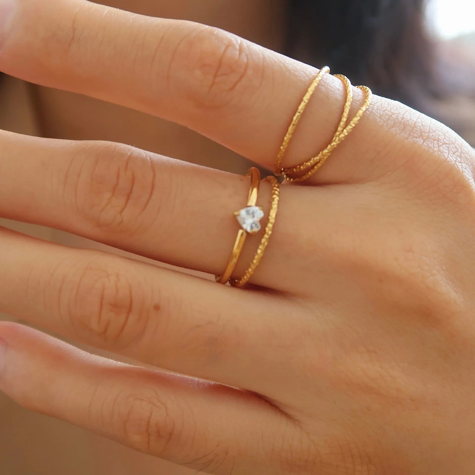Golden electroplated stainless steel love heart ring for women showing heart shape.