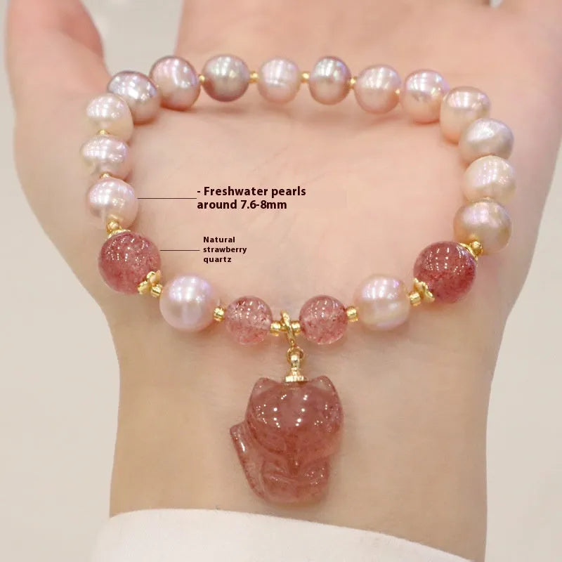 Women's light pink freshwater pearl bracelet with strawberry quartz and fox charm detailing