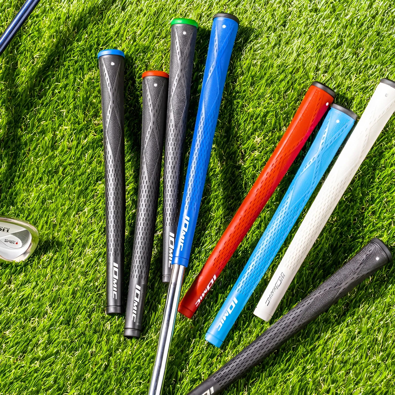 Soft TPE golf club grip shown in various colours including pink, red, blue, white, and black with coloured heads.
