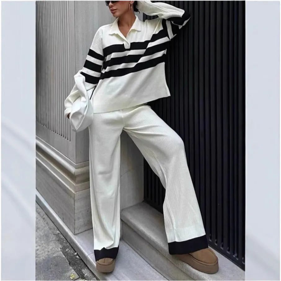 Women's black and white striped knitted two-piece set with a polo collar, featuring a long-sleeve top and trousers.