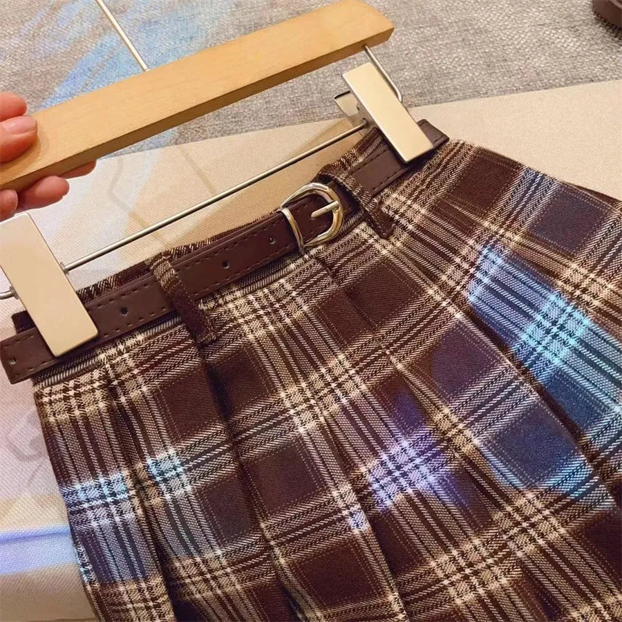 Girls' red and black plaid pleated A-line skirt on a hanger