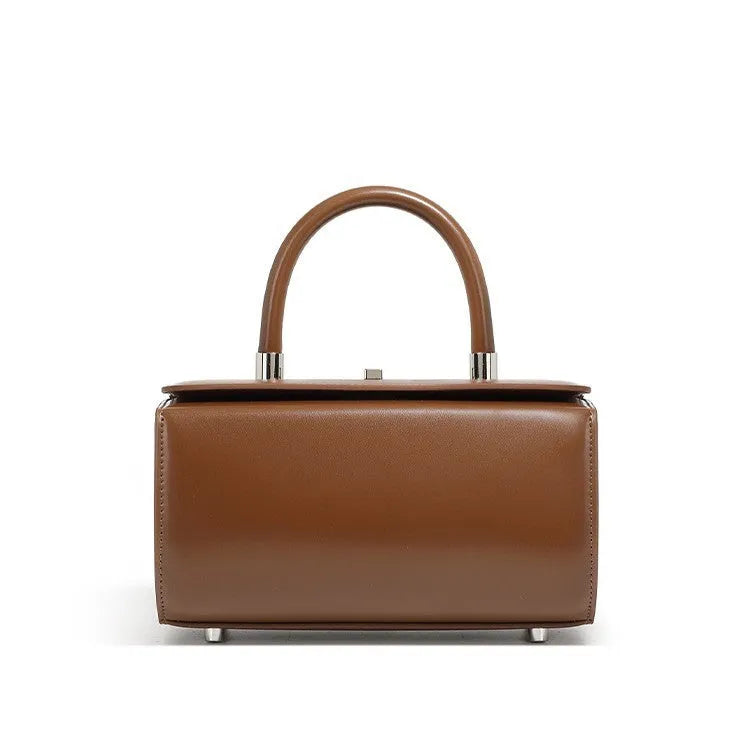 Women's black cowhide leather one-shoulder crossbody bag with clamshell opening, shown closed.