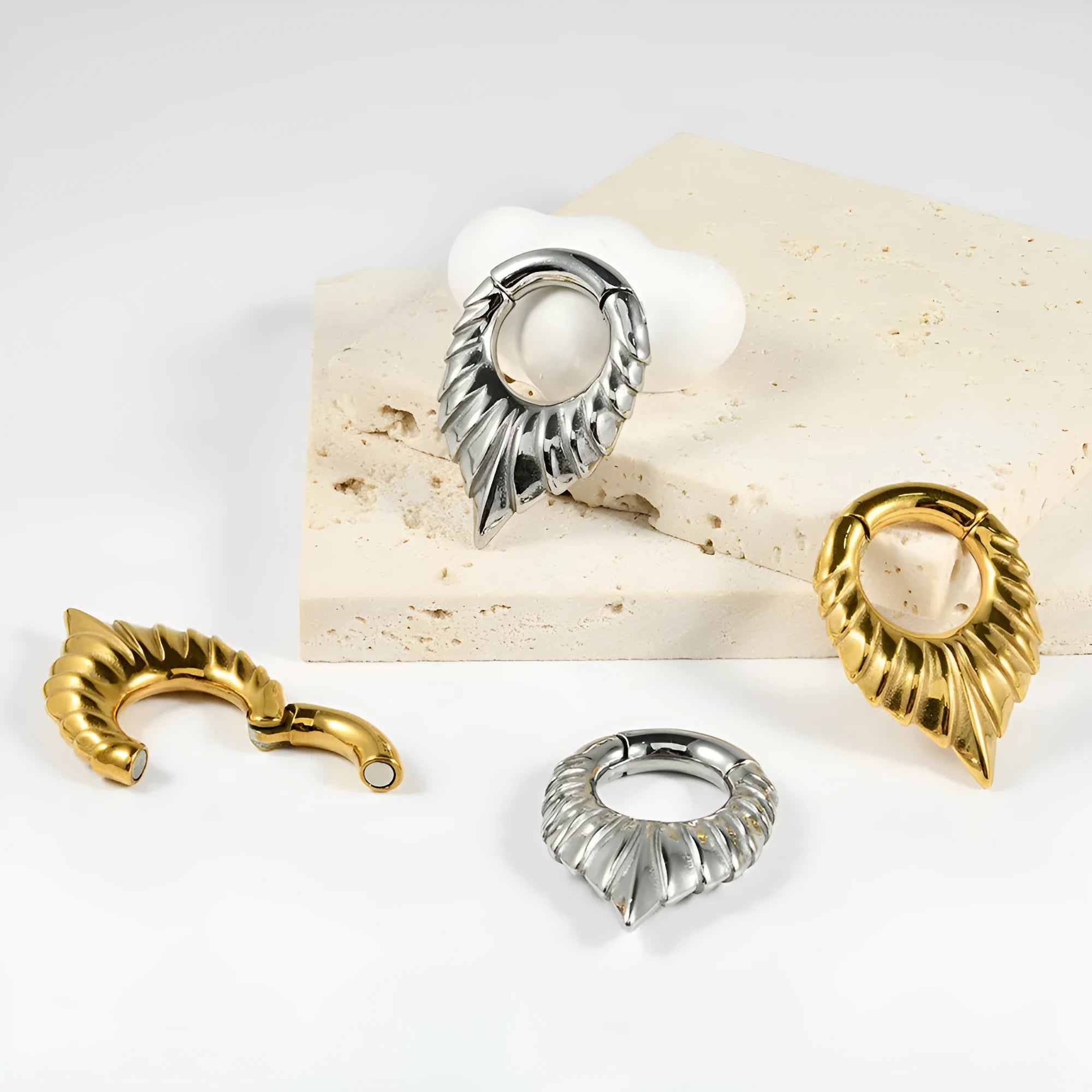 Stainless steel drop-shaped auricle ear extender with totem design for lobe stretching.