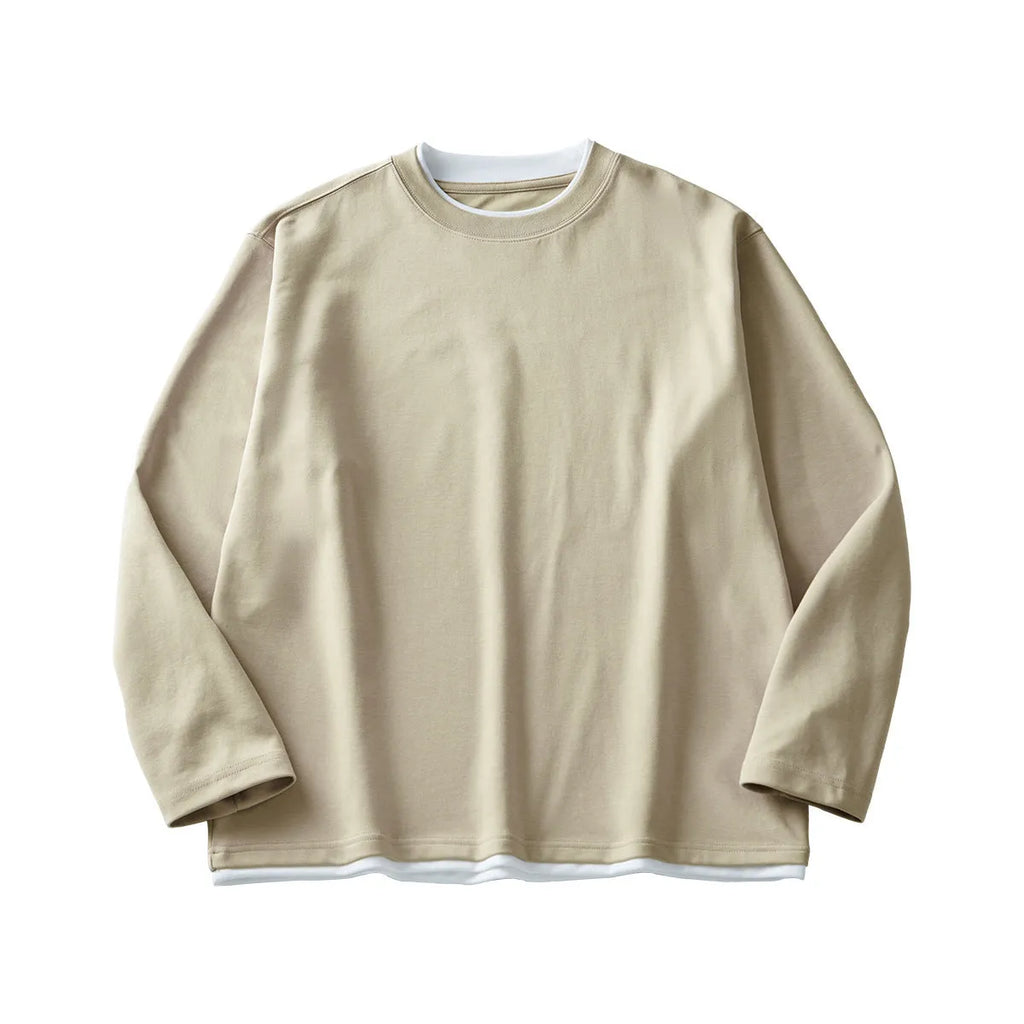 Man wearing a loose-fit long-sleeved grey cotton blend T-shirt with a round neck.