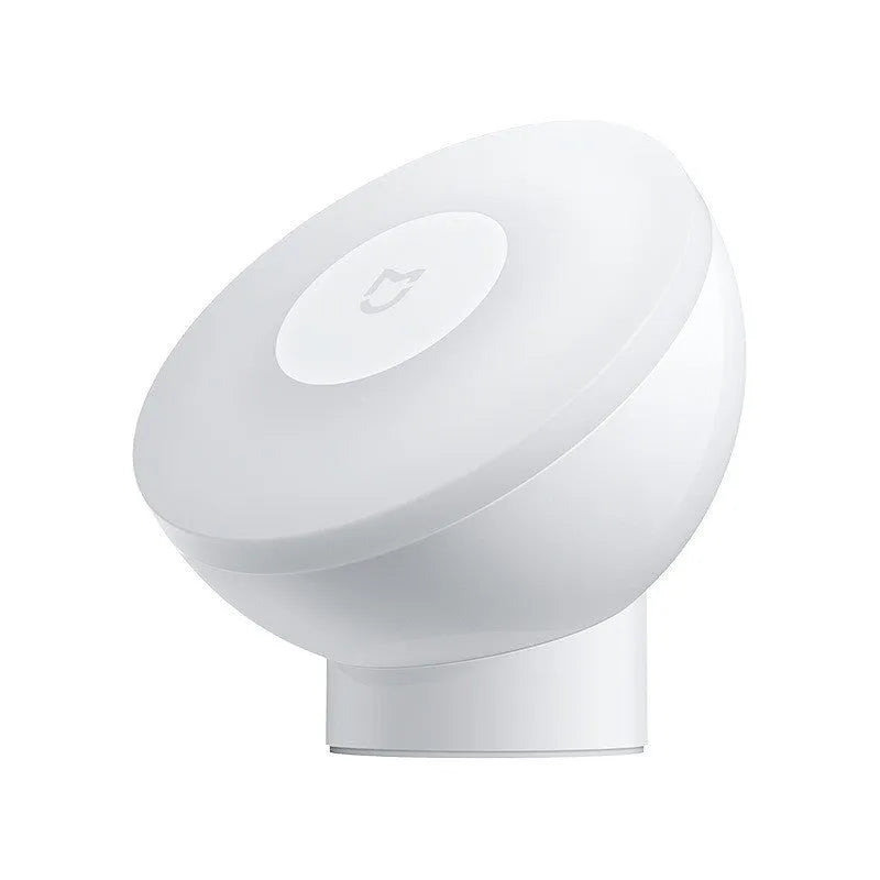 White modern bedside table lamp with sensor and Bluetooth on a wooden nightstand.