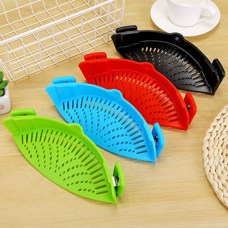 Silicone clip-on kitchen strainer with stainless steel frame attached to pot rim for draining liquids