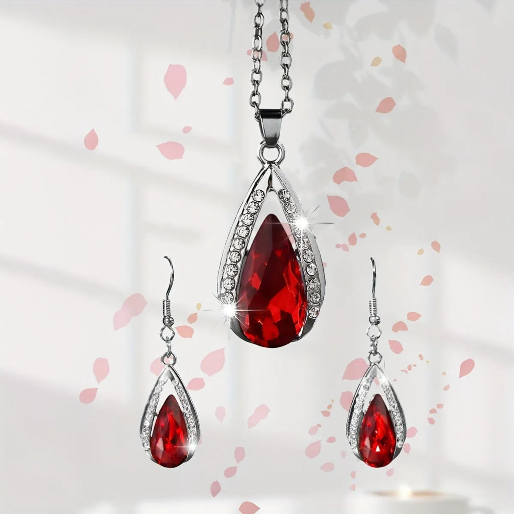 Black and red teardrop glass pendant necklace and matching earrings set on display.