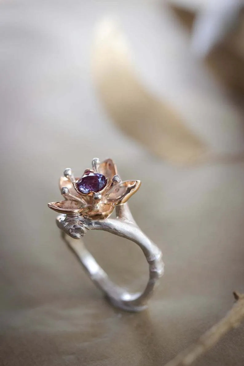 Silver two-tone floral geometric alloy women's ring shown on a white background.