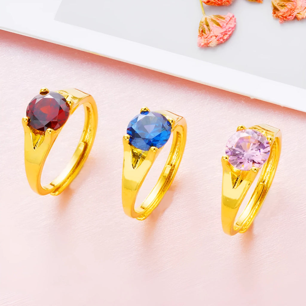 Adjustable copper ring with placer gold zircon accents shown in six colour options
