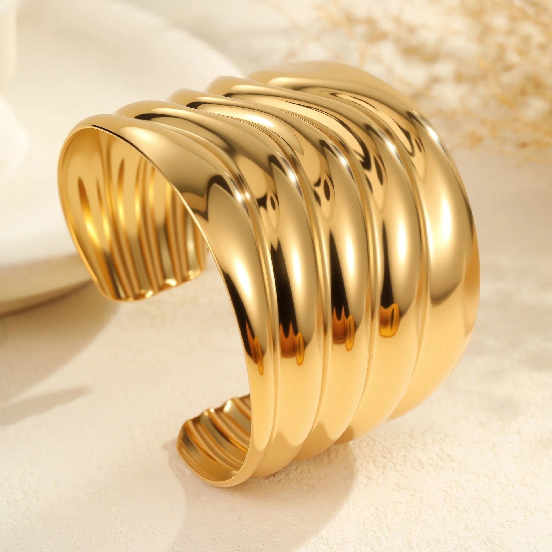 Women's gold plated stainless steel bracelet with wide geometric wave design and niche opening