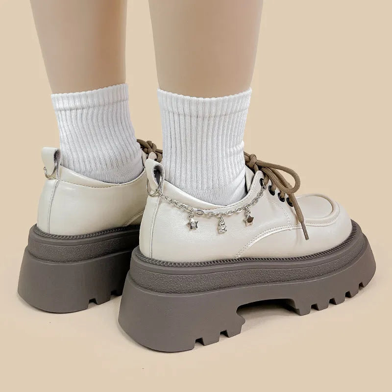 White platform leather shoes with chunky heel and front lace-up in Mary Jane style.