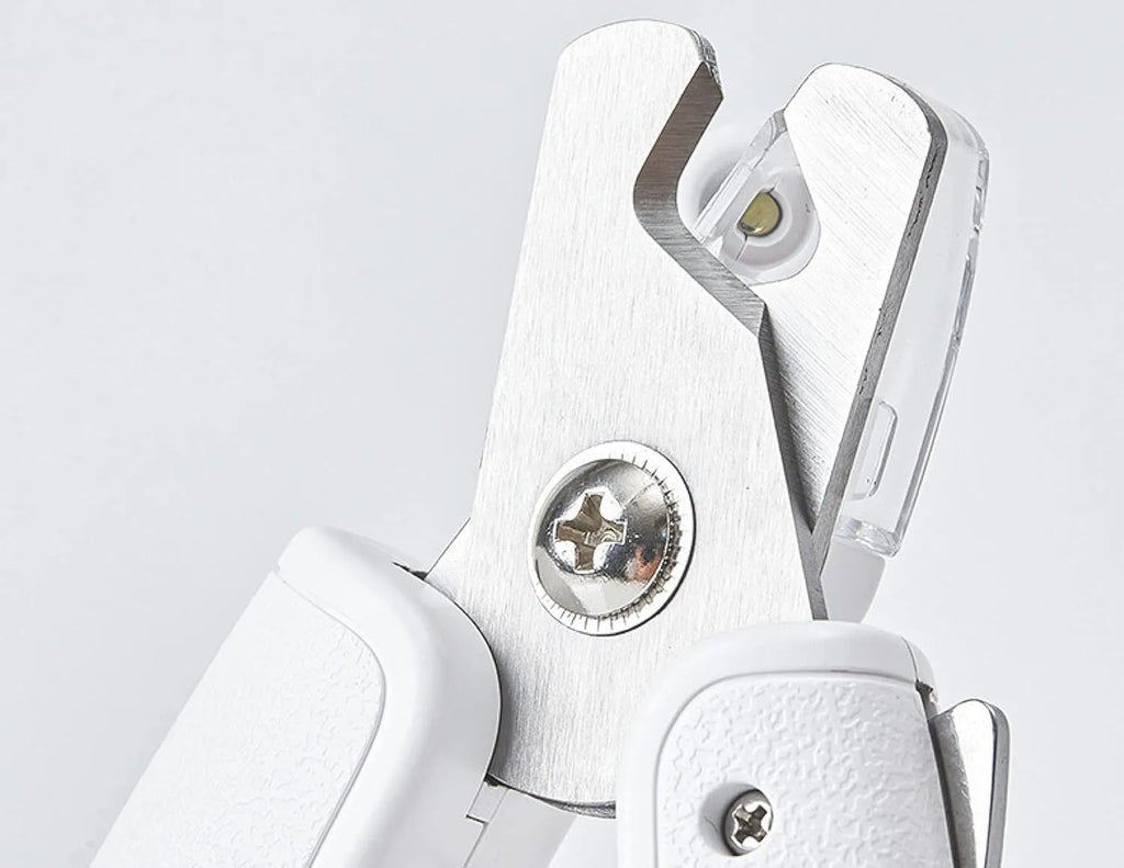 White pet nail clipper with LED light, transparent anti-splash guard, and leather-like handle
