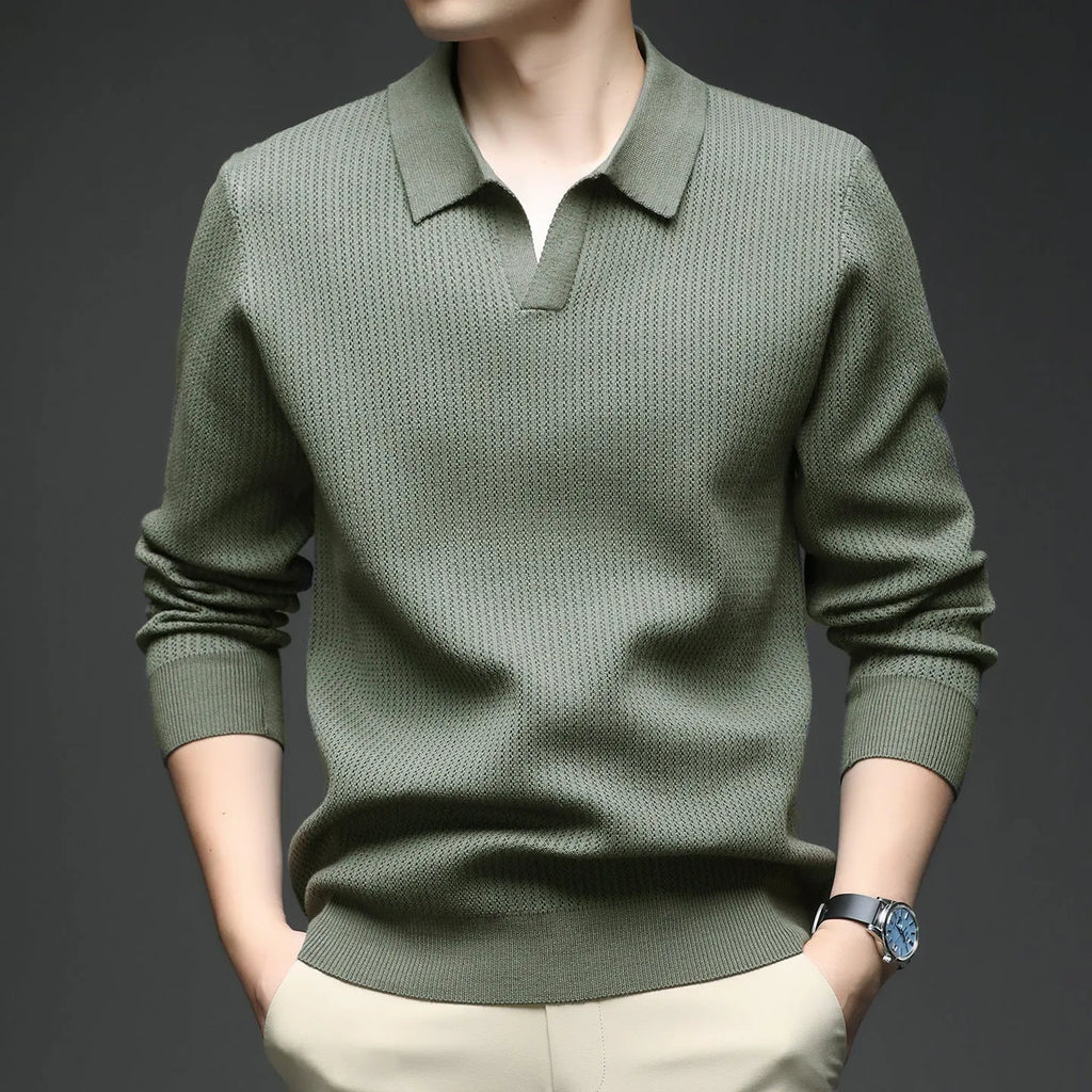 Man wearing a loose-fit green pullover sweater, a casual autumn garment.