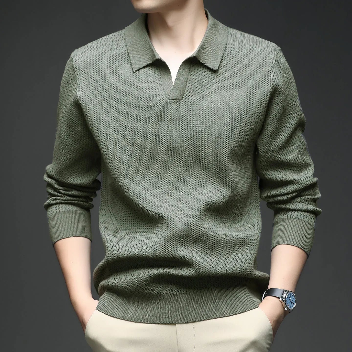 Man wearing a loose-fit green pullover sweater, a casual autumn garment.