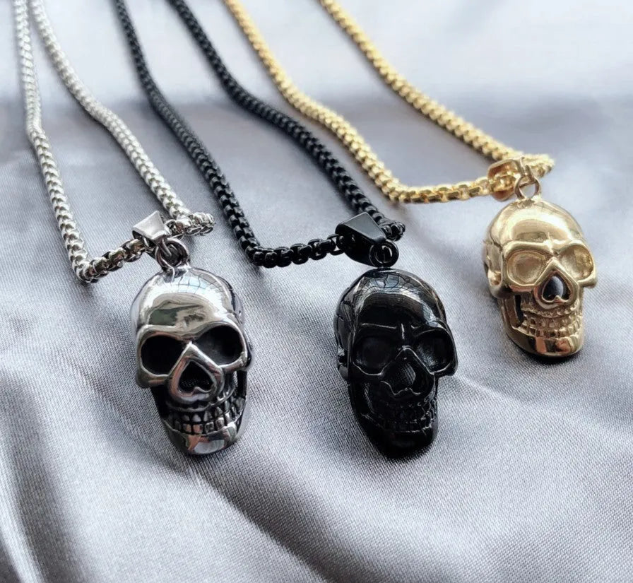 Halloween skull necklace in alloy and stainless steel with gold colour option on a black background