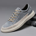 Men's grey pigskin leather low-top casual skate shoes with a round toe and rubber sole on a white background.