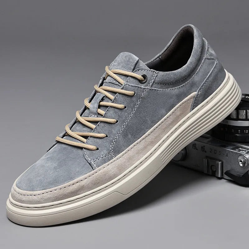 Men's grey pigskin leather low-top casual skate shoes with a round toe and rubber sole on a white background.