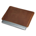 Brown horizontal computer liner bag made from cowhide leather showing laptop storage compartment