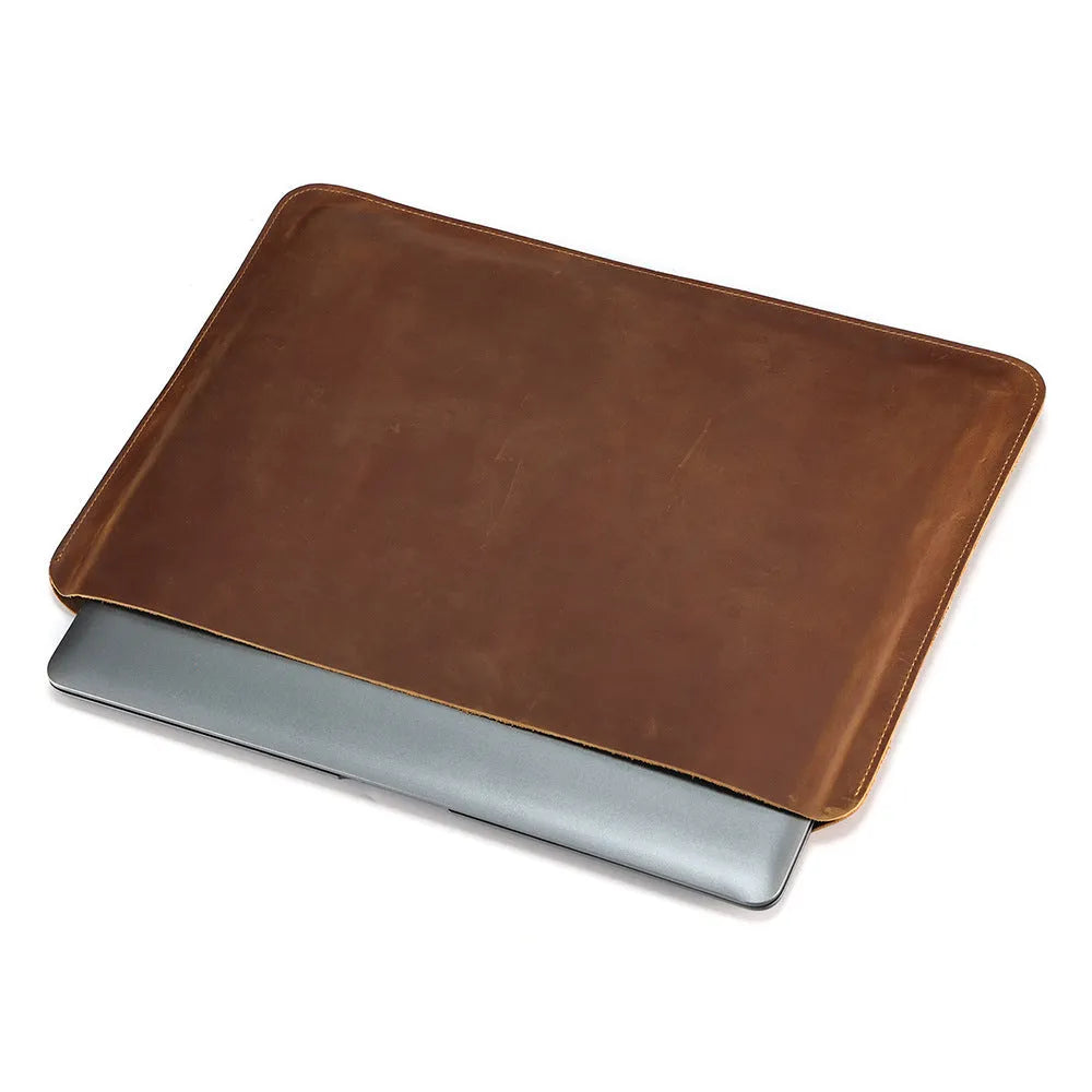 Brown horizontal computer liner bag made from cowhide leather showing laptop storage compartment