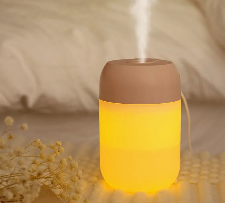 Small white cylindrical USB humidifier with aromatherapy function on desk