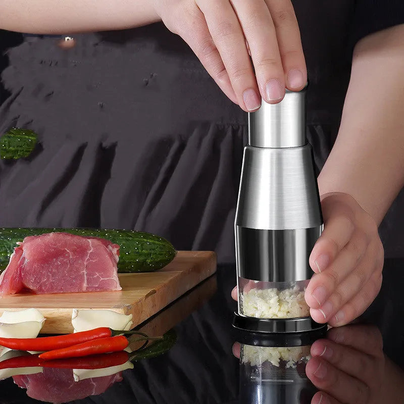 Black manual garlic press and vegetable chopper with stainless steel blades measuring 6x16cm