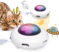 White automatic interactive cat toy with colourful feathers and LED lights on a floor.