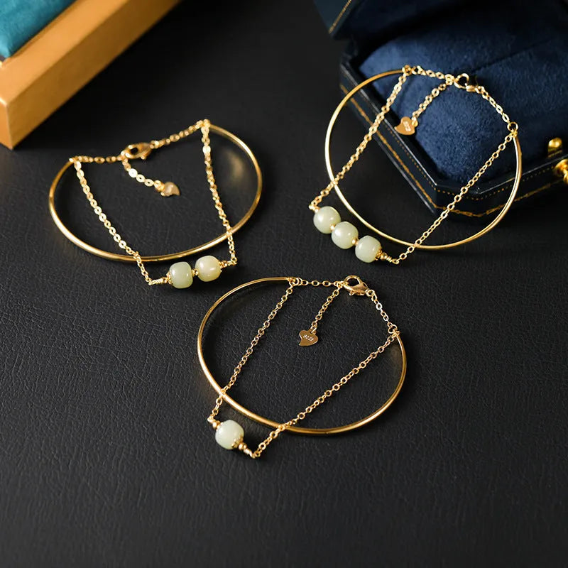 Women's jade bracelet with gold inlay lucky bead design in single, double, or three bead versions.