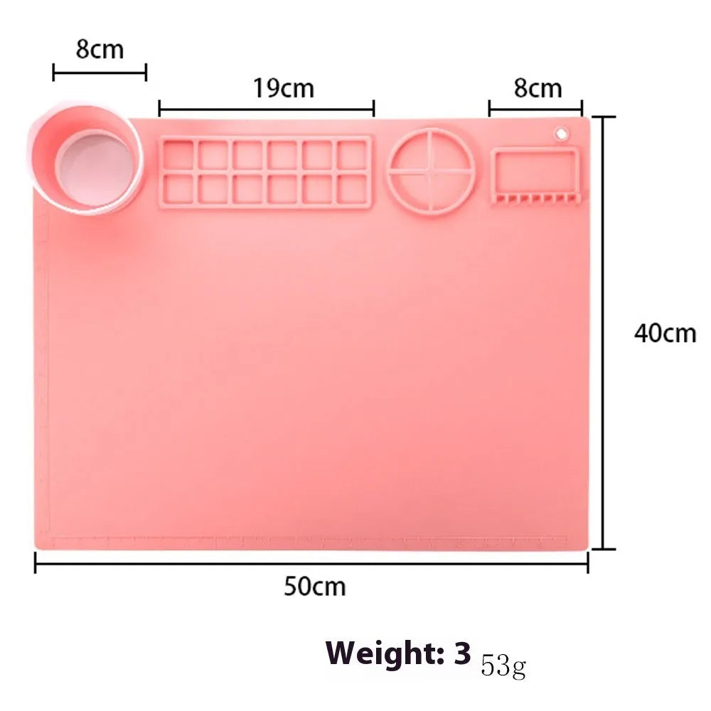 Light blue silicone painting mat measuring 50 by 40 centimetres with two round paint wells.