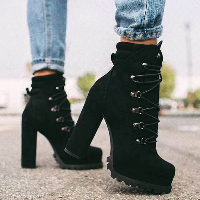 Women's army green suede Roman-style ankle boots with a thick high heel, round toe, and belt buckle detail.