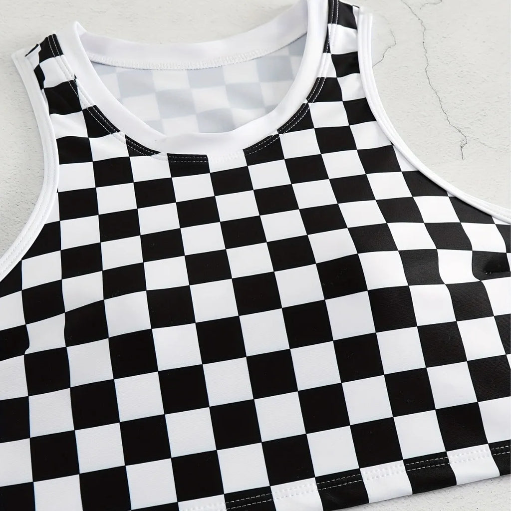 Backless one-piece women's swimsuit with black and white chessboard plaid pattern and white suspender straps.