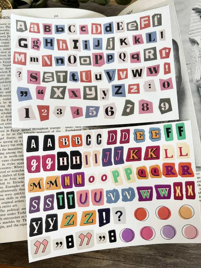 Sheets of cute printed stickers showing English letters A to Z, numbers, symbols, and weekly words like Monday and Friday.