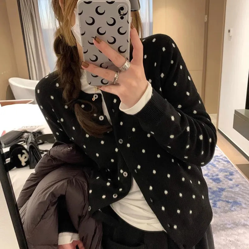 Women's grey and black Korean-style loose knit cardigan with crochet flower detail on the front.