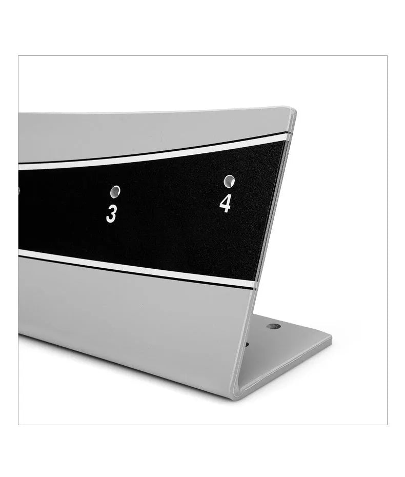 Close-up of an adjustable PVC golf putter trajectory balance simulator on a flat surface.