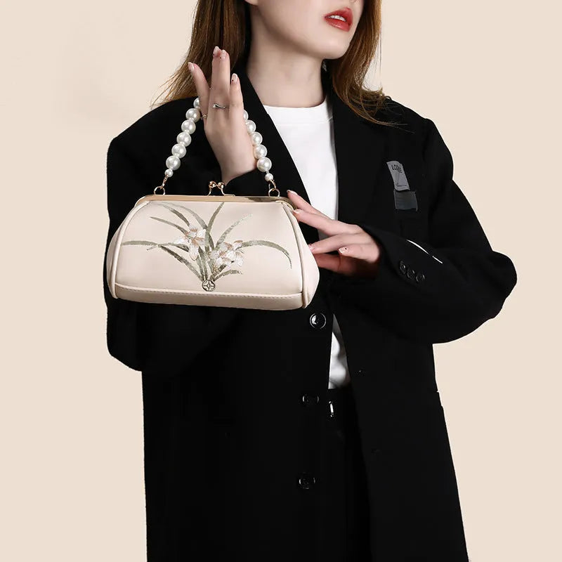Beige women's shoulder bag with floral embroidery on soft PU leather material