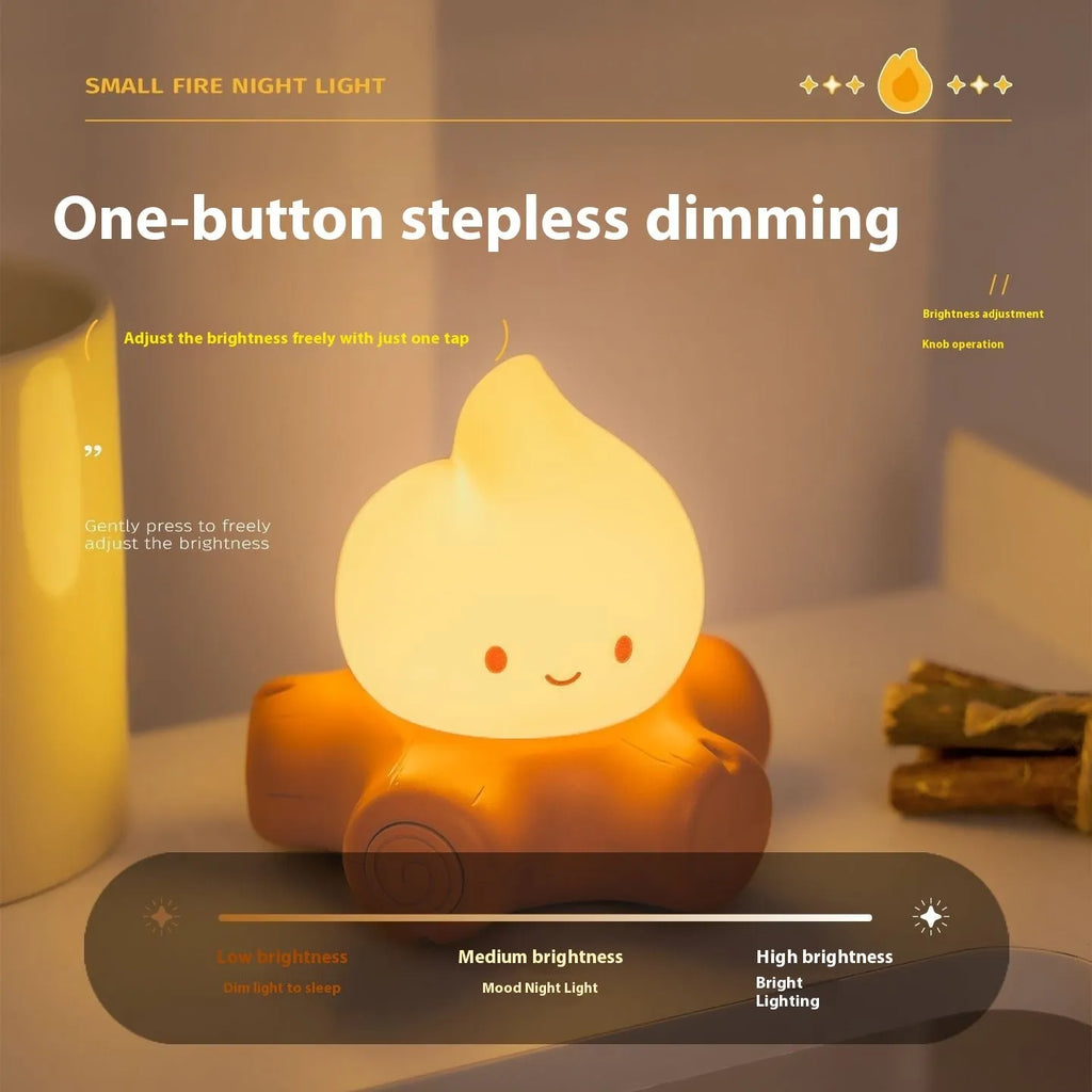 Small yellow silicone cartoon fire pile night lamp with ABS plastic shade on a table