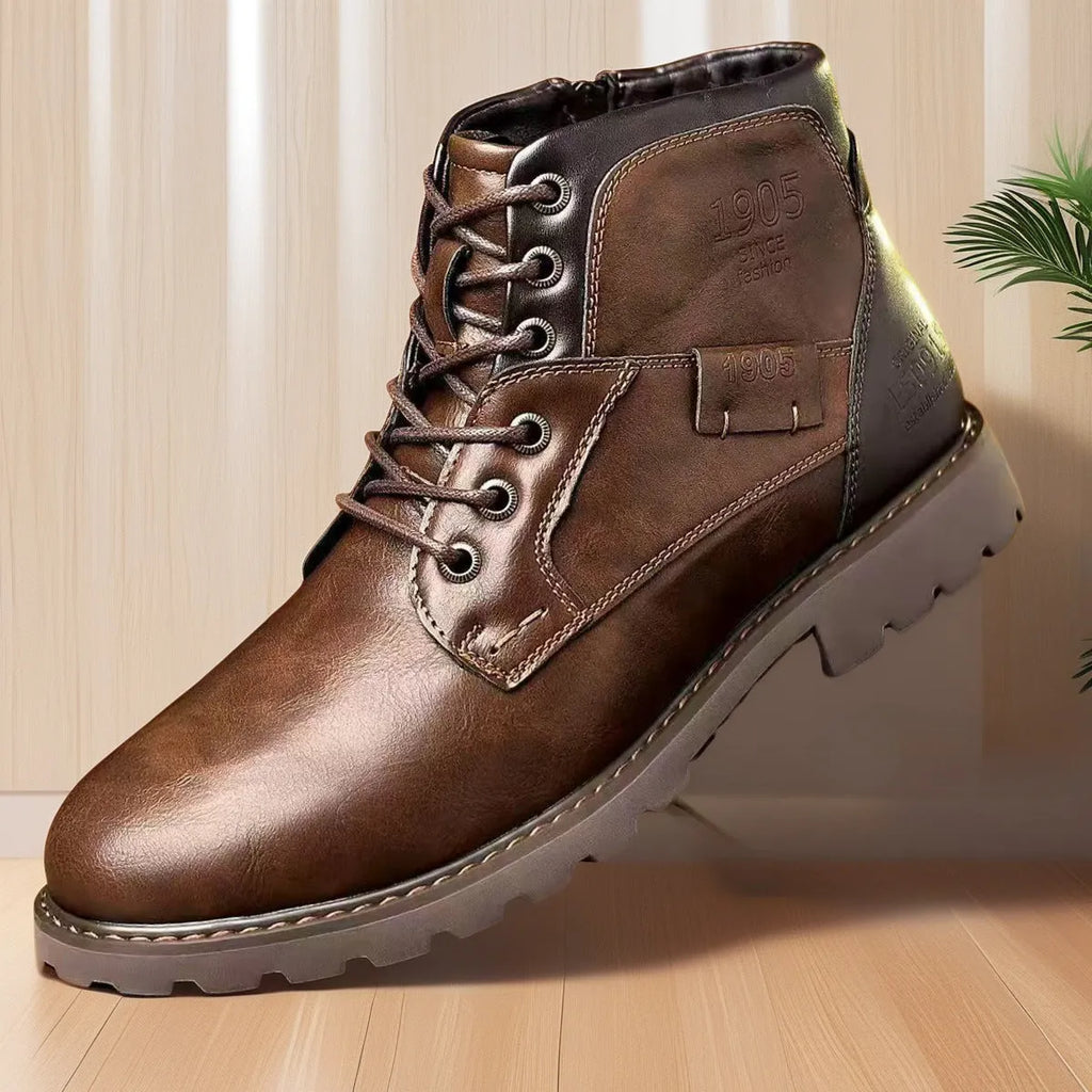 Brown men's ankle boot with a side zip, round toe, and rubber sole on a plain background.