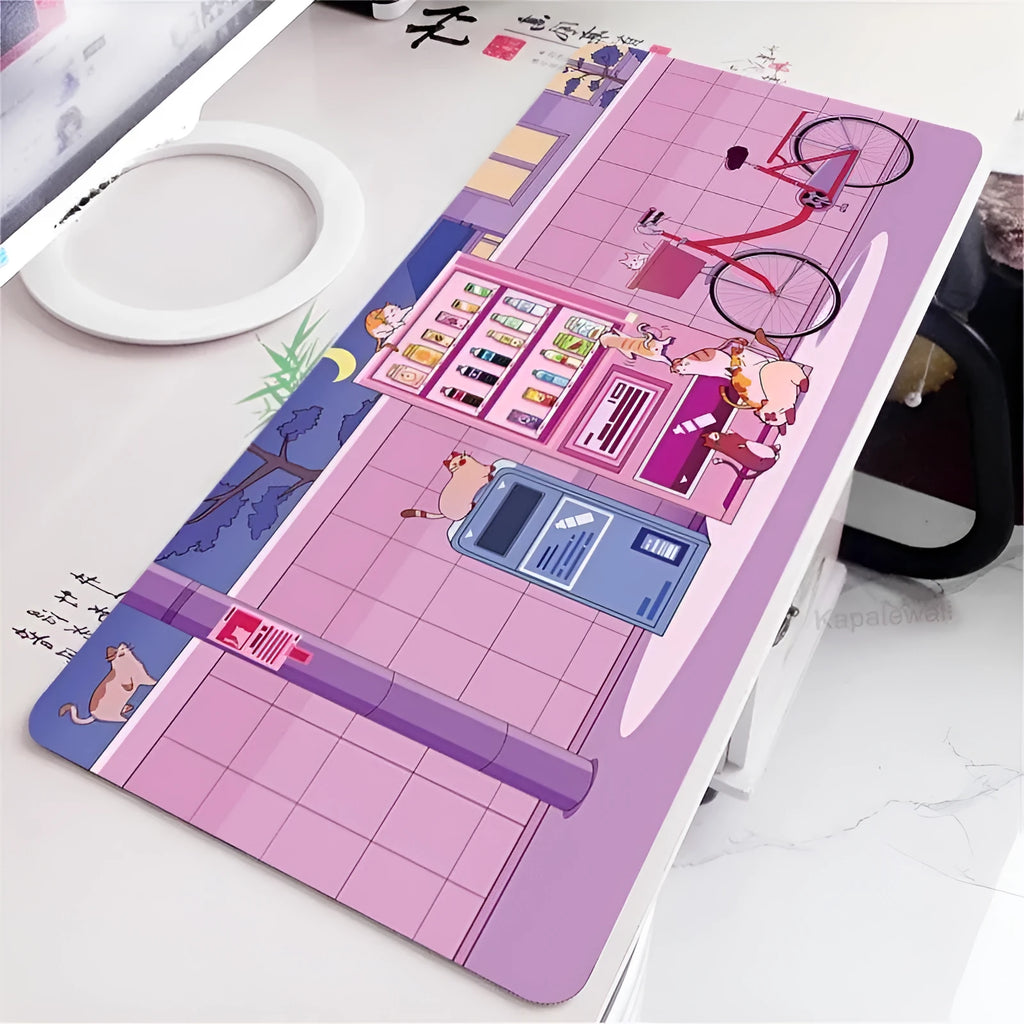 Oversized cat head design desk mat in various colours and sizes on a wooden desk.