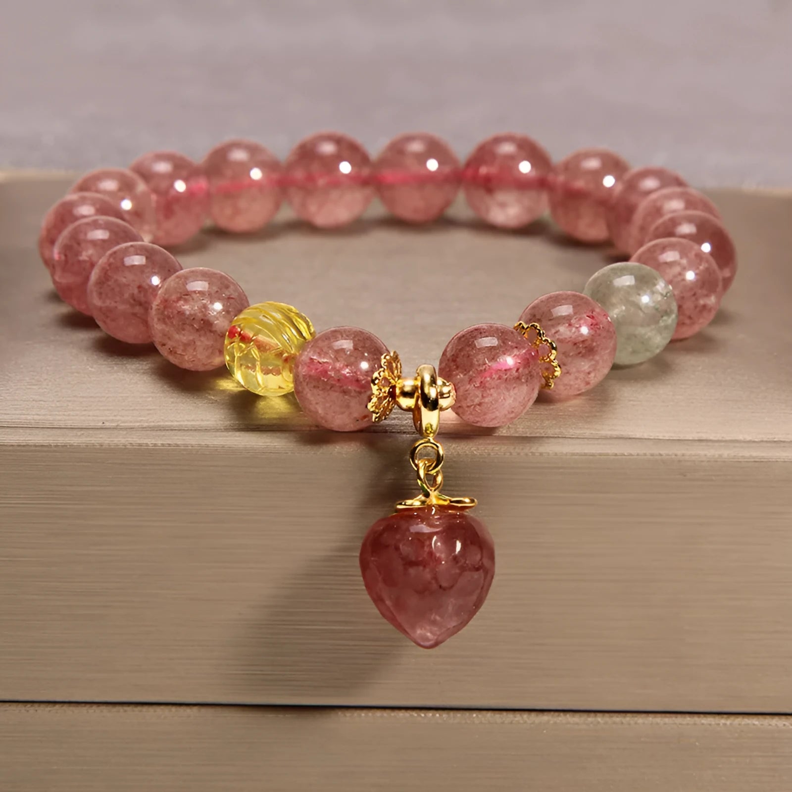 Women's multi-layer crystal bracelet with natural garnet, strawberry quartz pendants, and jinsi jade beads in assorted colours.